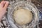 Woman hand cover dough in glass bowl using cling film before proofing