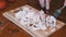 Woman Hand Cuts Cooked Chicken Fillet on a Cutting Board with a Fork and Knife.