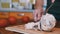 Woman Hand Cuts Cooked Chicken Fillet on a Cutting Board with a Fork and Knife.