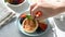 Woman hand decorating breakfast pancakes with mint leaf