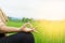 Woman hand doing yoga and meditation over nature green field