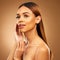 Woman with hand on face, skin and haircare with bronze glow and luxury salon treatment on brown background. Beauty