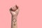 A woman hand and feminist sign tattoos on her hand isolate on pink background