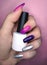 Woman hand finger pink violet purple silver metallic manicure gel nail polish swatch design white bottle beauty photo