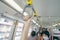 Woman hand firm grip safety handrail in elevated monorail train. Mass transit system in modern city. Inside of electric train.