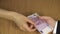 Woman hand give 500 euro cash banknote bribe from envelope. 4K