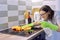 Woman hand in gloves cleaning kitchen electric ceramic hob