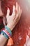 Woman hand in hair with boho style jewelry, beads bracelets and ring closeup outdoor summer
