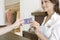 Woman Hand Handing Credit Card at Counter