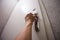 Woman hand hold door handle of apartment from steep stairs