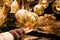 Woman hand holding beautifully crafted Christmas decoration ball in gold colour with ornamental design