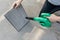 Woman hand holding blower to clean dirty air purifier