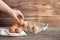 Woman hand holding chicken eggs, brown eggs, organic egg on calico at wooden rustic table. Natural eggs product concept