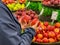 Woman hand holding and choosing red apples at marketplace