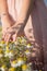 Woman hand holding daisies growing in the field