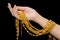 Woman hand holding expensive golden chains