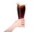 Woman hand holding fresh Cola with ice cubes