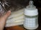 Woman hand holding frozen breast milk in storage bags and baby bottle with fresh expresed breastmilk