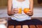 Woman hand holding a glass of orange juice for breakfast,Excretory good system concept