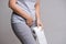Woman hand holding her crotch lower abdomen and tissue or toilet paper roll. Disorder, Diarrhea, incontinence. Healthcare concept
