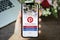 Woman hand holding iPhone X with social Internet service Pinterest