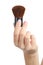 Woman hand holding a makeup brush