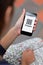 Woman hand holding mobile phone with QR code coupon