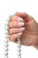 Woman hand holding pearl jewelery