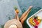 Woman hand holding pineapple near tray with served Breakfast in swimming pool.