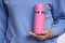 Woman hand holding pink vacuum bottle