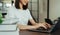 woman hand holding press the button on the keyboard laptop and stack of books.