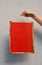 Woman hand holding red warning sign over wall