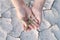 Woman hand holding seedlings are growing from arid soil with morning sun is shining, concept of global warming