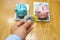 Woman hand holding silver and golden bitcoin with piggybank background