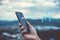 Woman hand holding smartphone with vital sign of heart beat background. Business technology health connection