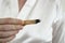 woman hand holding a stick of sacred palo santo wood, burning.