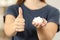 Woman hand holding sugar cubes with thumbs up