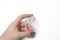 Woman hand holding transparent silicone sponge with a drop of foundation