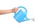 Woman hand holding a watering can