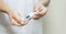 Woman hand holds analogue medical thermometer to  measure the body temperature, protection from virus