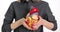 Woman hand holds model of human heart on body