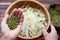 Woman hand with homemade bean sprouts, germinate of green beans