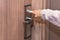 Woman hand inserting card to open electronic lock in hotel door