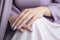 Woman hand with lavender color nail polish on her fingernails. Purple nail manicure with gel polish at luxury beauty salon. Nail