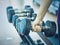 Woman hand lifting dumbbell in gymnasium