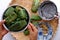 Woman hand making flat rice dumpling, stuffing from vegetable onto rice flour, vegan rice cake leaf from Hue