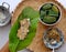 Woman hand making flat rice dumpling, stuffing from vegetable onto rice flour, vegan rice cake leaf from Hue