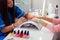 Woman hand on manicure treatment in beauty salon. Beauty parlour