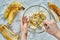 Woman hand mashing up several bananas