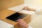 Woman hand open or close laptop on wood table